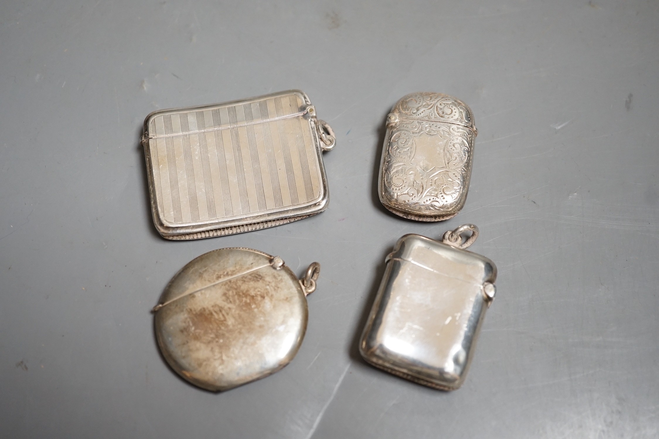 Four assorted late 19th/early 20th century silver vesta cases, including circular, 42mm.